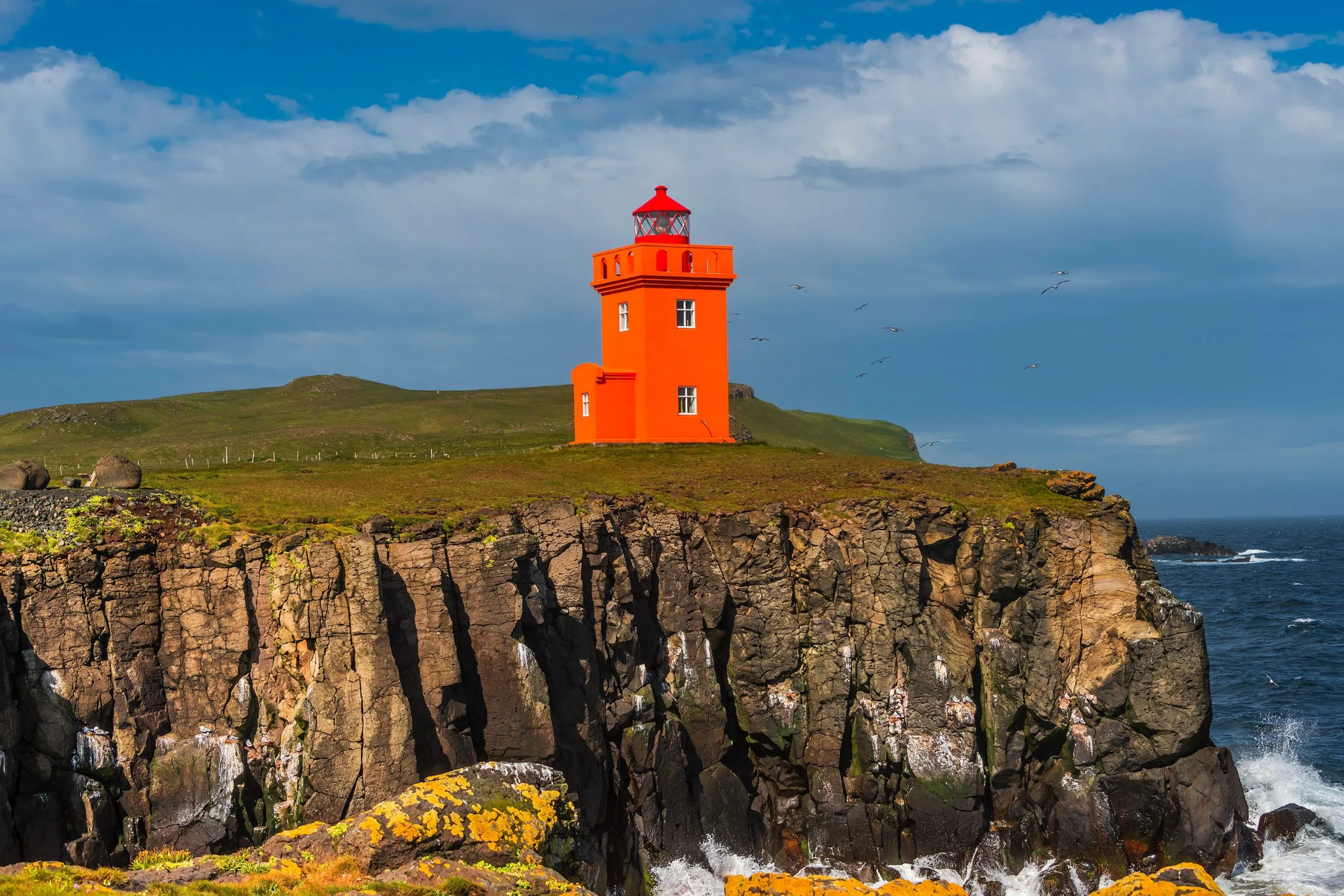 Orange lighthouse at seashore of Grimsey island nearby Iceland,