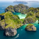 Aerial drone view of tropical Ko Phi Phi island, beaches and boats in blue clear Andaman sea water from above, beautiful archipelago islands of Krabi, Thailand
