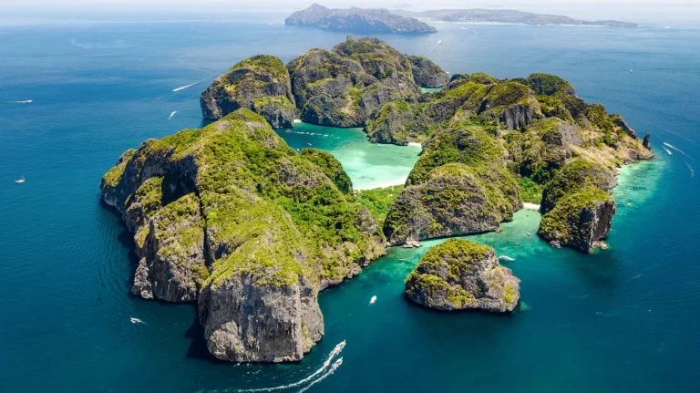 Aerial drone view of tropical Ko Phi Phi island, beaches and boats in blue clear Andaman sea water from above, beautiful archipelago islands of Krabi, Thailand