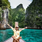 Maya Bay Koh Phi Phi Thailand, Turquoise clear water Thailand Koh Pi Pi, Scenic aerial view of Koh Phi Phi Island in Thailand. Asian woman mid age with hat in longtail boat