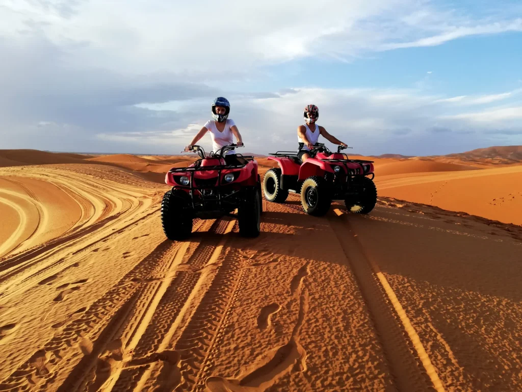 Couple driving quads in the sahara desert