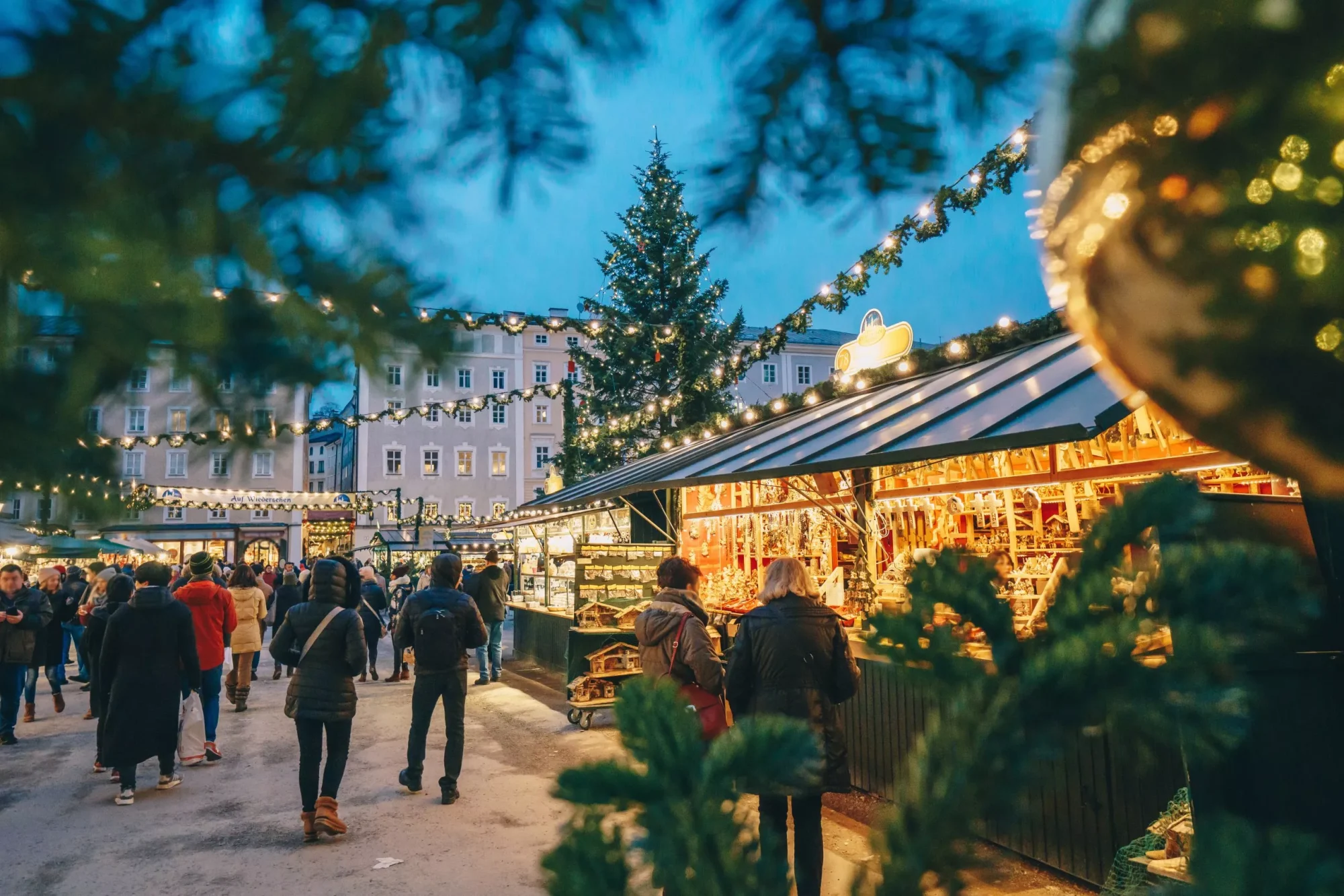 Salzburg christmas market seen trough a christmas tree branches stockpack adobe stock scaled