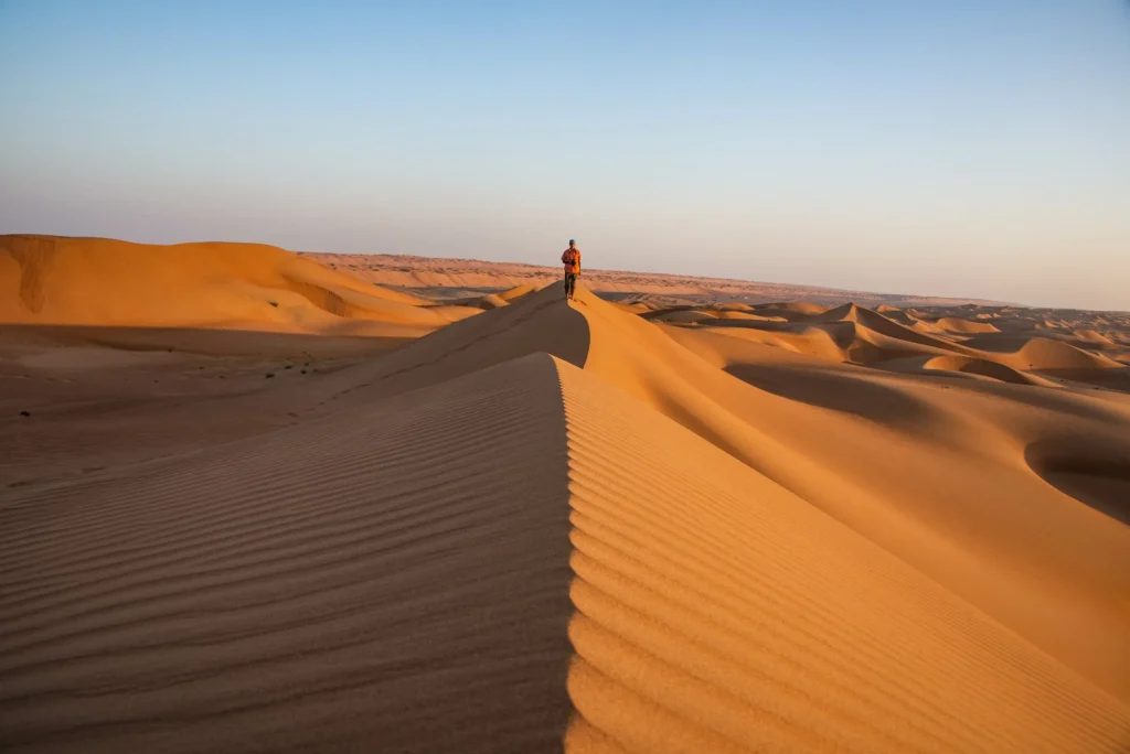 Walking in desert sand dunes, Wahiba Sands, Ash Sharqiyah, Oman