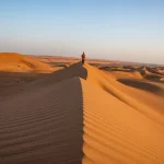 Walking in desert sand dunes, Wahiba Sands, Ash Sharqiyah, Oman